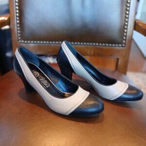 Stout heeled pumps in taupe and black leather.